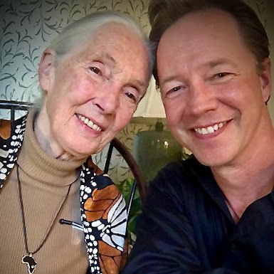 Color photograph of Dr. Jane Goodall and Dr. Brad McLain sitting together and smiling toward the viewer.