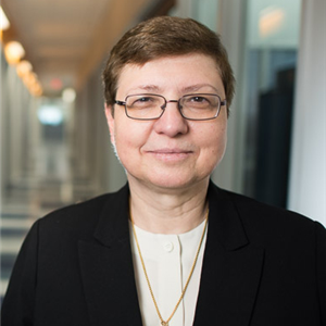Color photo of Dr Klara Nahrstedt wearing glasses and smiling toward the viewer